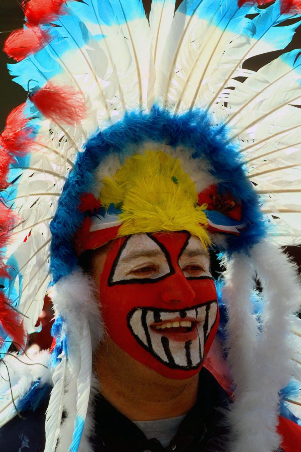 FILE - Cleveland Indians fan Mike Margevicus waits to enter Jacobs Field for the team's home opener in Cleveland, in this Friday, April 10, 1998, file photo. While moving forward with a plan to change their name, the Cleveland Indians said they will not permit fans inside Progressive Field wearing headdresses or inappropriate face paint. The team announced the new guidelines on Wednesday, March 31, 2021, in advance of Monday's home opener against Detroit. (AP Photo/Mark Duncan, File)