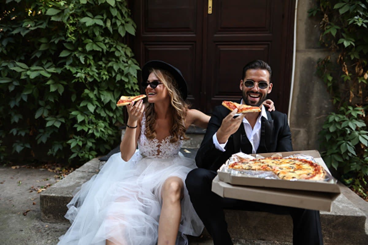 Wedding guests order pizza and wings when food supply runs out  (Getty Images)