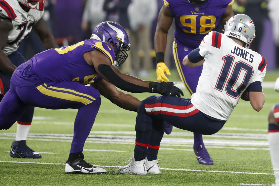 Minnesota Vikings linebacker Danielle Hunter, left, sacks New England Patriots quarterback Mac Jones (10) during the second half of an NFL football game, Thursday, Nov. 24, 2022, in Minneapolis. The Vikings won 33-26. (AP Photo/Bruce Kluckhohn)