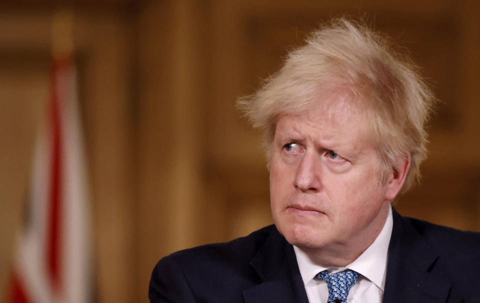 Britain's Prime Minister Boris Johnson speaks during a media briefing in Downing Street, London, Monday Dec. 21, 2020. (Tolga Akmen/Pool via AP)