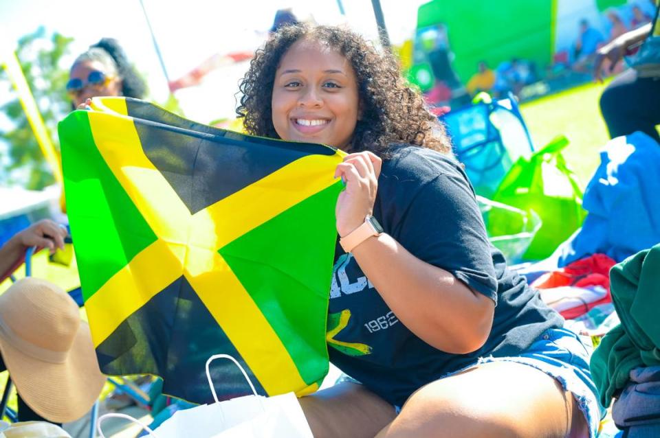 A festivalgoer waves a Jamaican flag at the Grace Jamaican Jerk Festival.