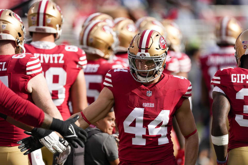 FILE -San Francisco 49ers fullback Kyle Juszczyk (44) is greeted by teammates before an NFL football game against the Seattle Seahawks on Sunday, Dec. 10, 2023, in Santa Clara, Calif. Kyle Juszczyk remembers the different feel when he took the field for the first time in the playoff rivalry between his San Francisco 49ers and the Green Bay Packers. The teams are set to meet for the third time in the past five postseasons on Saturday night, Jan. 20, 2024 when the Packers (10-8) visit the 49ers (12-5) in the record-setting 10th playoff meeting between the franchises.(AP Photo/Godofredo A. Vásquez, File)