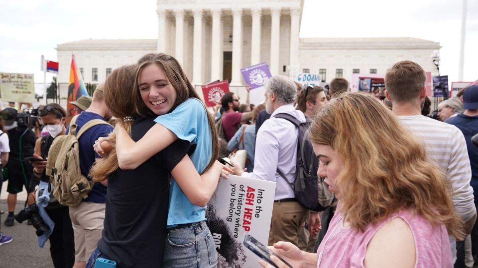 TOPSHOT - Pro-life supporters hug outside the US Supreme Court in Washington, DC, on June 24, 2022. - The US Supreme Court on Friday ended the right to abortion in a seismic ruling that shreds half a century of constitutional protections on one of the most divisive and bitterly fought issues in American political life. The conservative-dominated court overturned the landmark 1973 