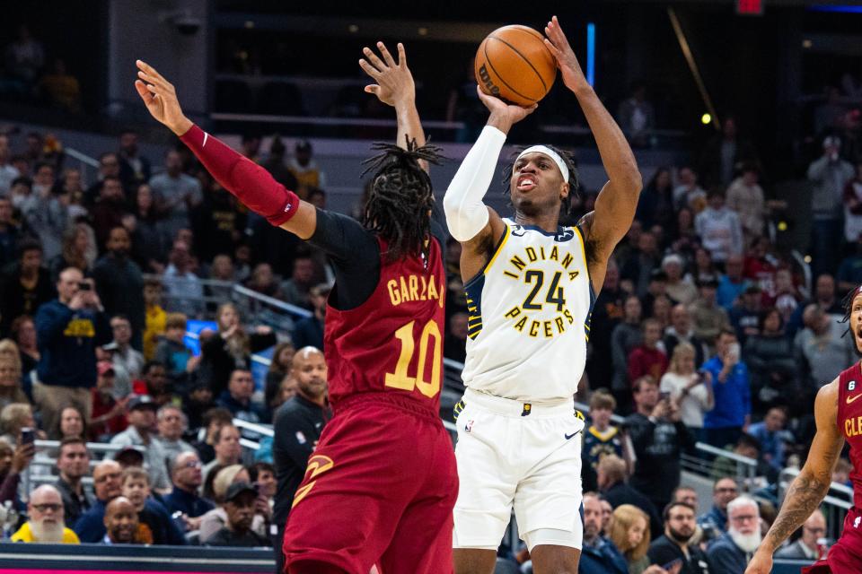 Indiana Pacers guard Buddy Hield (24) shoots the ball while Cleveland Cavaliers guard Darius Garland (10) defends at Gainbridge Fieldhouse.