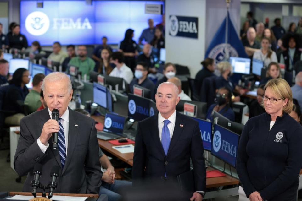 (L-R) President Joe Biden speaks as Homeland Security Secretary Alejandro Mayorkas and Federal Emergency Management Agency (FEMA) Administrator Deanne Criswell look on during a visit on Sept. 29, 2022 to FEMA headquarters in Washington, D.C. (Photo by Oliver Contreras / AFP) (Photo by OLIVER CONTRERAS/AFP via Getty Images)