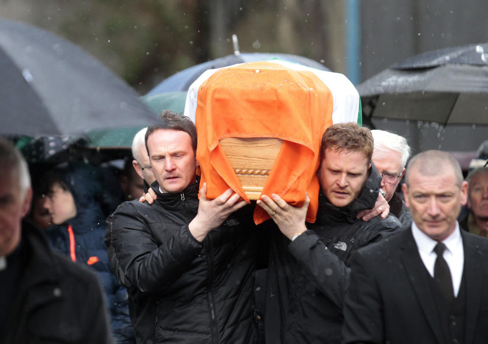 Emmett and Fiachra McGuinness carry the coffin of their father Martin through the bogside area of Londonderry, Northern Ireland, Tuesday, March, 21, 2017. Martin McGuinness, the Irish Republican Army warlord who led his underground, paramilitary movement toward reconciliation with Britain, and was Northern Ireland's deputy first minister for a decade in a power-sharing government, has died, his Sinn Fein party announced Tuesday on Twitter. He was 66.(AP Photo/Peter Morrison)