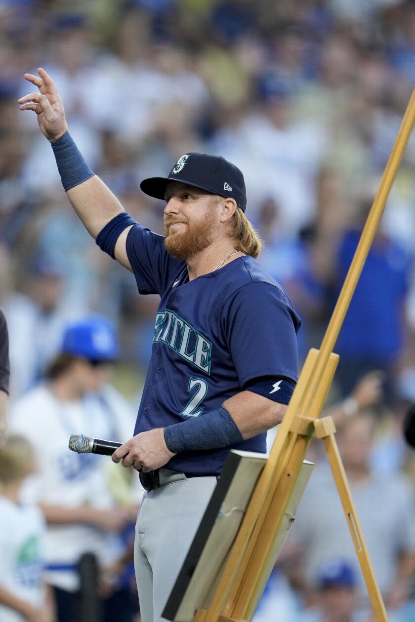 Justin Turner waves to the crowd during his pre-game celebration at Dodger Stadium on Monday.