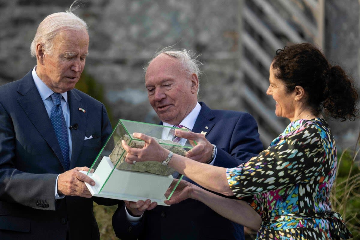 Mr Biden was presented with a brick from the former Blewitt family home that Caffrey recovered under his family store that is located on the site of the original home (AFP via Getty Images)