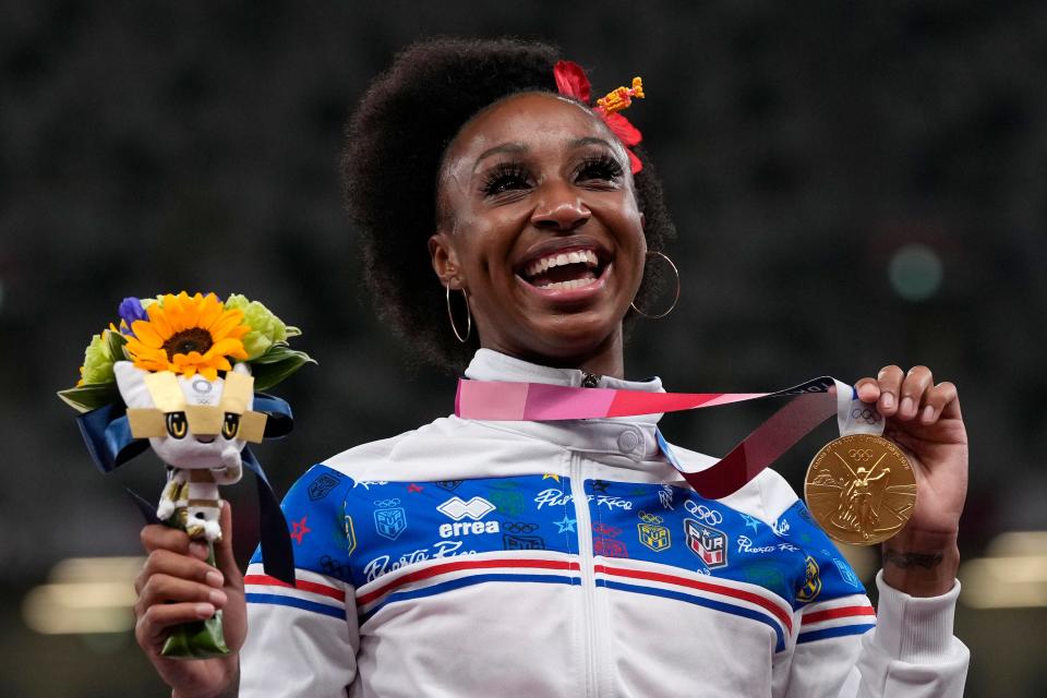 Jasmine Camacho-Quinn, of Puerto Rico, poses with her gold medal after winning the women's 100-meters hurdles final at the 2020 Summer Olympics, Monday, Aug. 2, 2021, in Tokyo. (AP Photo/Francisco Seco)