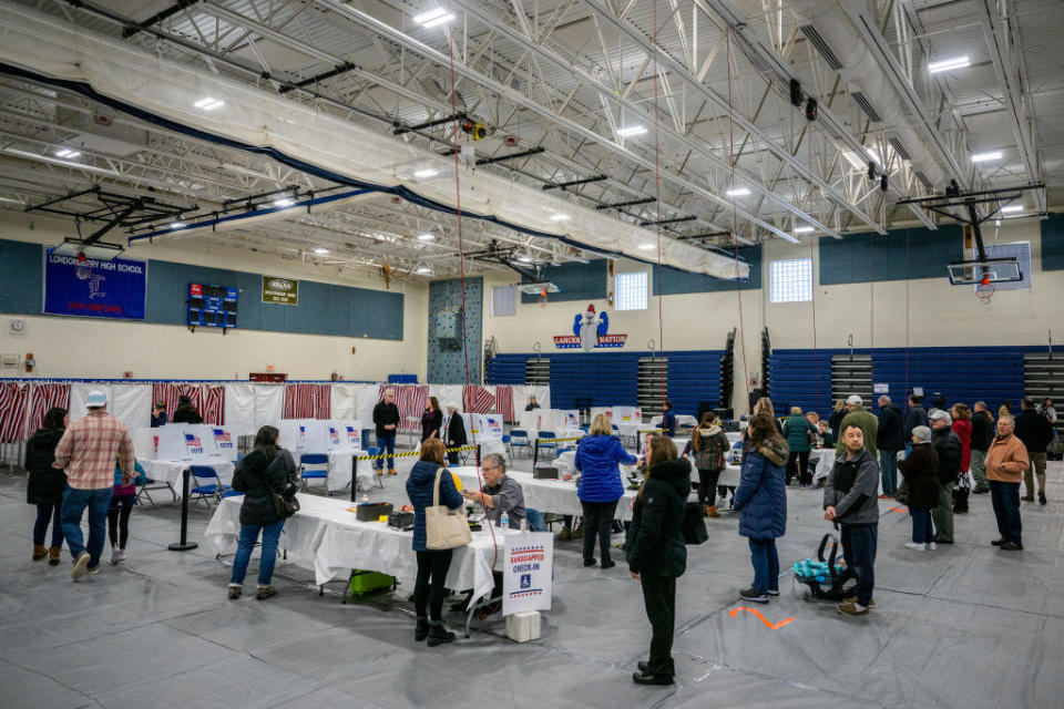 People stand in line in preparation to cast their ballots in the New Hampshire primary at Londonderry High School on Jan. 23, 2024, in Londonderry, New Hampshire. / Credit: BRANDON BELL / Getty Images