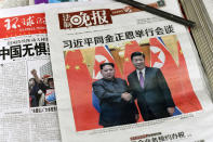 <p>The front pages of Chinese evening newspapers, showing images of China’s President Xi Jinping with North Korean leader Kim Jong Un, are displayed at a newspaper stand in Beijing on March 28, 2018. (Photo: Fred Dufour/AFP/Getty Images) </p>