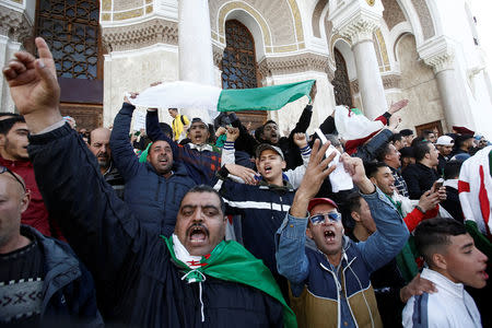 People chant slogans and carry national flags during a protest against the appointment of interim president Abdelkader Bensalah demanding radical changes to the political system, in Algiers, Algeria April 10, 2019. REUTERS/Ramzi Boudina