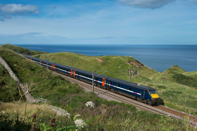High speed East Coast Trains train on the East Coast Main Line running alongside the coast in the North of England.
