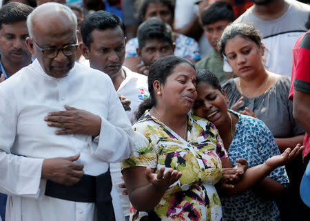 FILE PHOTO: People react during a mass burial of victims, two days after a string of suicide bomb attacks on churches and luxury hotels across the island on Easter Sunday, in Colombo, Sri Lanka April 23, 2019. REUTERS/Dinuka Liyanawatte