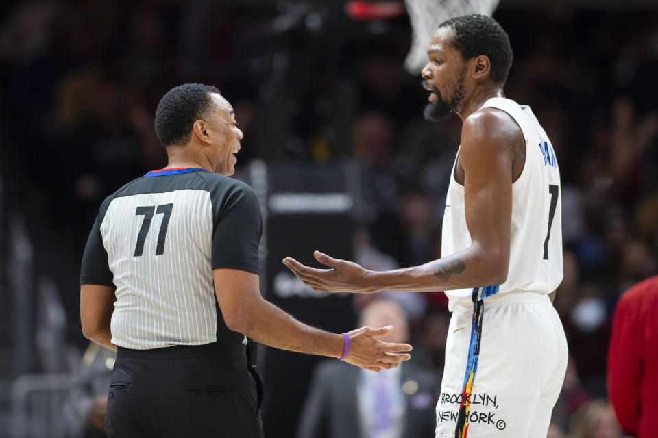 Brooklyn Nets forward Kevin Durant speaks with referee Karl Lane during the first half of an NBA basketball game against the Atlanta Hawks, Wednesday, Dec. 28, 2022, in Atlanta. (AP Photo/Hakim Wright Sr.)