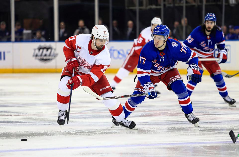 Detroit Red Wings center Dylan Larkin (71) and New York Rangers center Frank Vatrano (77) battle for the puck during the third period at Madison Square Garden.
