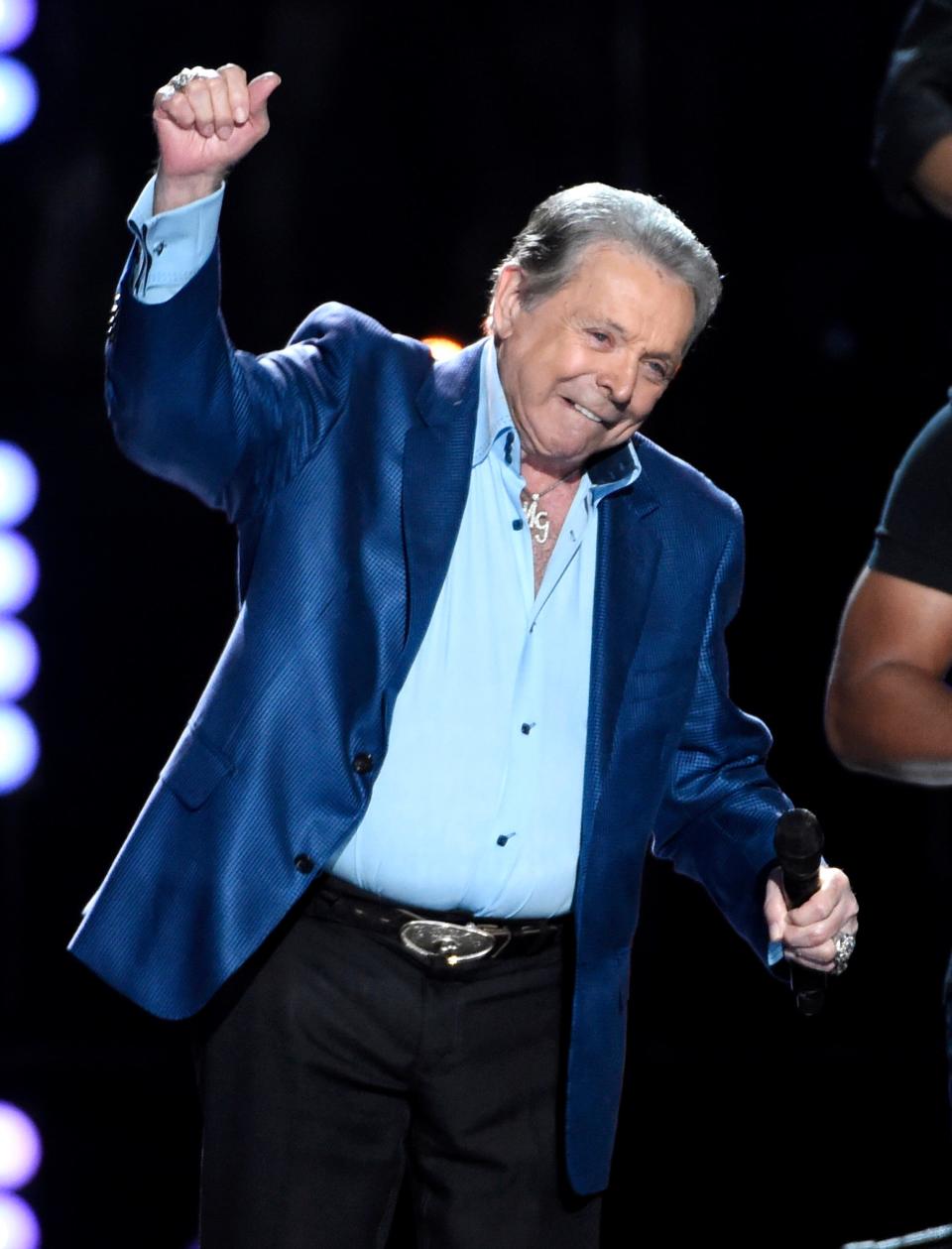 FILE - Mickey Gilley accepts the triple crown award at ACM Presents Superstar Duets at Globe Life Park on Friday, April 17, 2015, in Arlington, Texas. Gilley, whose namesake Texas honky-tonk inspired the 1980 film “Urban Cowboy,” and a nationwide wave of Western-themed nightspots, died Saturday, May 7, 2022, at age 86. (Photo by Chris Pizzello/Invision/AP, File) ORG XMIT: NYSB681