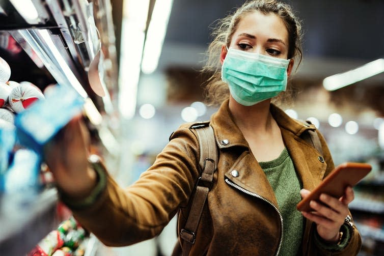 <span class="caption">Wearing a mask can be difficult for some people with asthma.</span> <span class="attribution"><a class="link " href="https://www.shutterstock.com/image-photo/young-woman-face-mask-using-mobile-1685691625" rel="nofollow noopener" target="_blank" data-ylk="slk:Drazen Zigic/Shutterstock;elm:context_link;itc:0;sec:content-canvas">Drazen Zigic/Shutterstock</a></span>