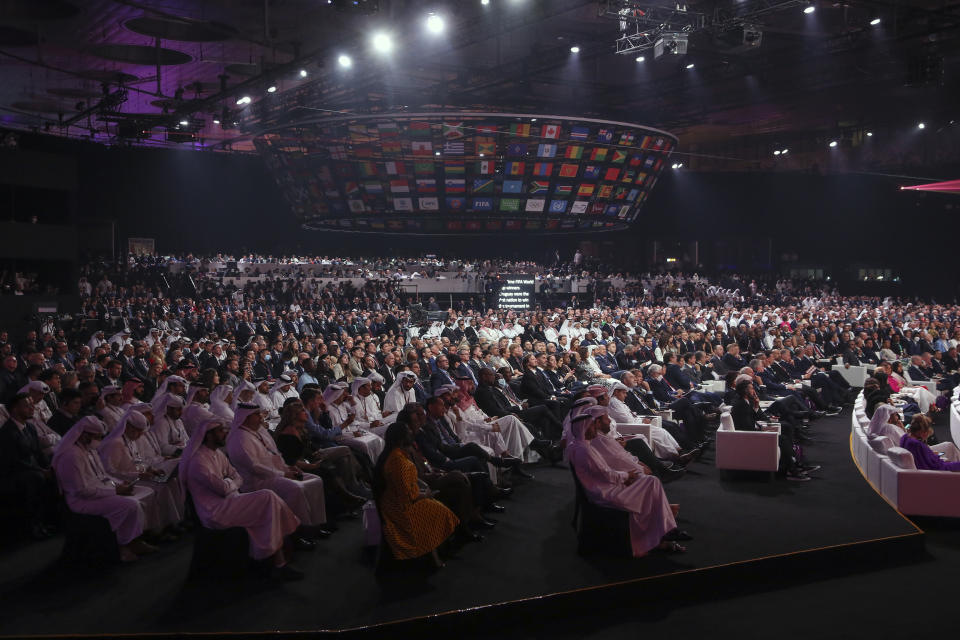 People attend the 2022 soccer World Cup draw at the Doha Exhibition and Convention Center in Doha, Qatar, Friday, April 1, 2022. (AP Photo/Hussein Sayed)