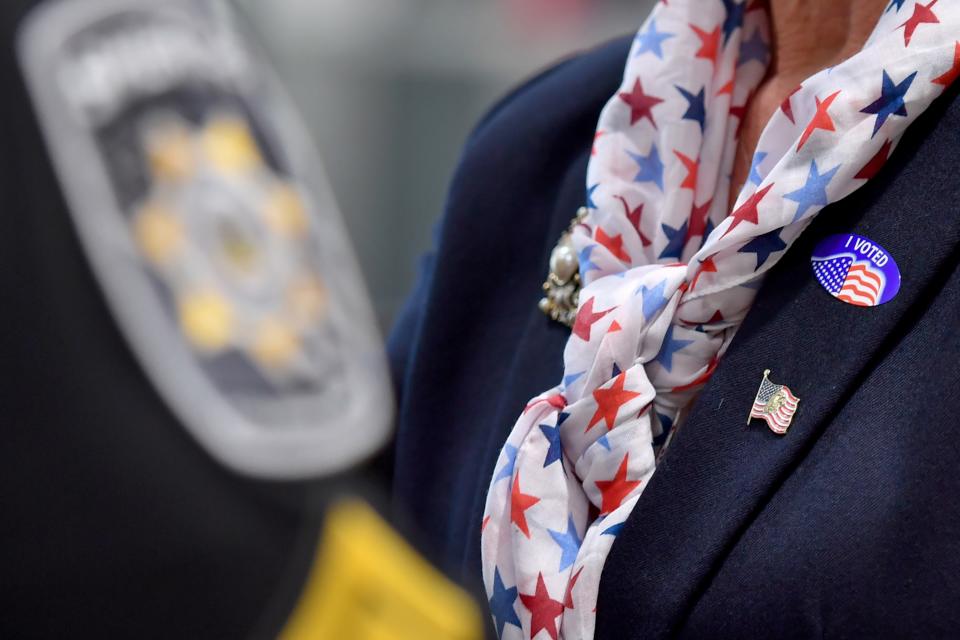 <h1 class="title">A woman wears an "I voted" sticker, red, white, blue, and an</h1><cite class="credit">SOPA Images/Getty Images</cite>