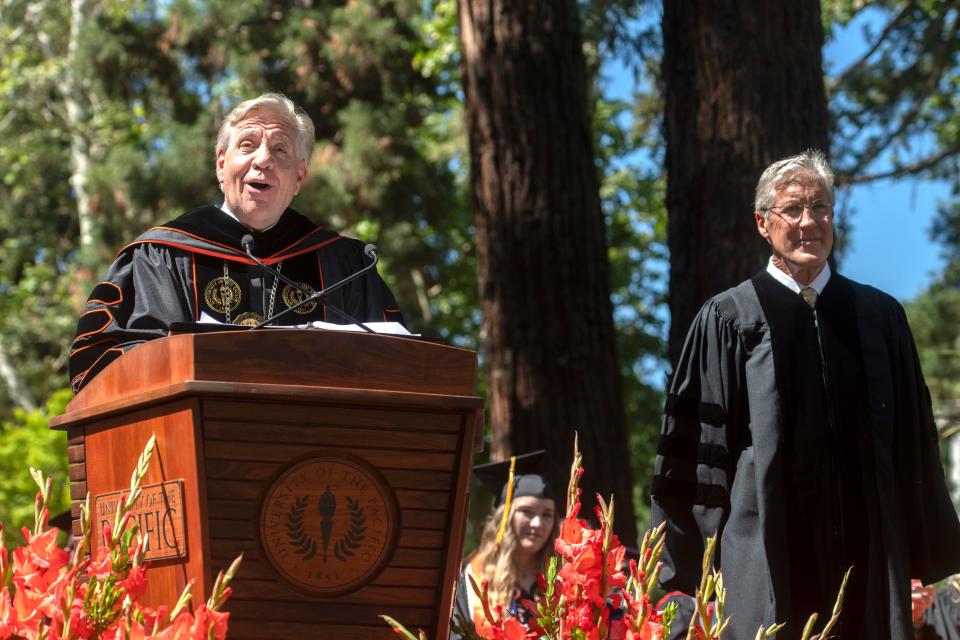 University of the Pacific President Christopher Callahan, left, confers an honorary MBA degree upon Seattle Seahawks head coach Pete Carroll an honorary MBA degree during the 2022 commencement ceremonies.