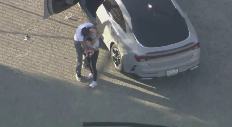 The suspect was seen hugging his girlfriend and daughter before they were taken into custody on July 17, 2024. (KTLA)