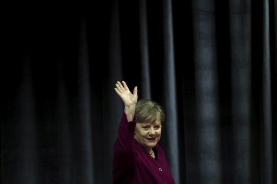 German Chancellor Angela Merkel waves the students during her visit in a German school in Athens, Friday, Jan. 11, 2019. Merkel is widely blamed in Greece for the austerity that the country has lived through for much of the past decade, which led to a sharp and prolonged recession and a consequent fall in living standards. (AP Photo/Petros Giannakouris)