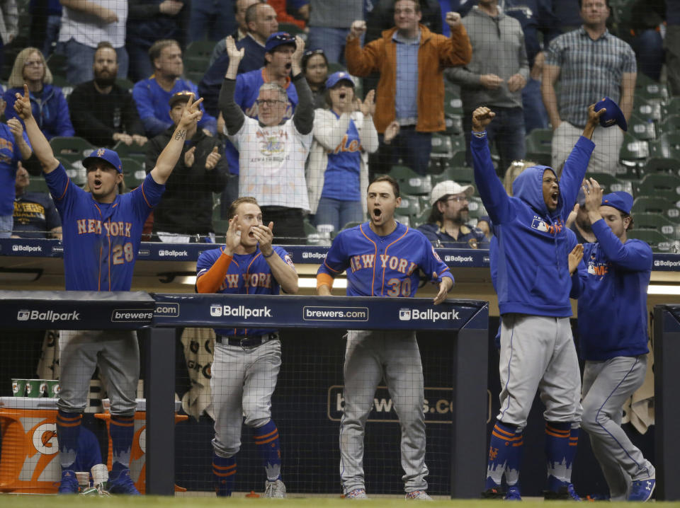 The team bench reacts to New York Mets' Jeff McNeil RBI single against the Milwaukee Brewers during the 18th inning of a baseball game Saturday, May 4, 2019, in Milwaukee. (AP Photo/Jeffrey Phelps)