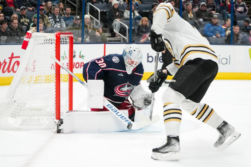 Nov 27, 2023; Columbus, Ohio, USA; Columbus Blue Jackets goaltender Spencer Martin (30) stops a shot from Boston Bruins center Charlie Coyle (13) during the second period of the NHL game at Nationwide Arena.