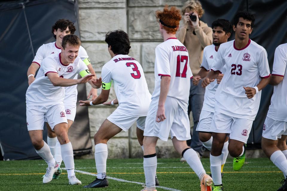 Westborough's Chris Deane, left, is congratulated by Max Aires, center, and the rest of his team after scoring to go up 1-0 over Wachusett on Tuesday September 19, 2023 in Holden.