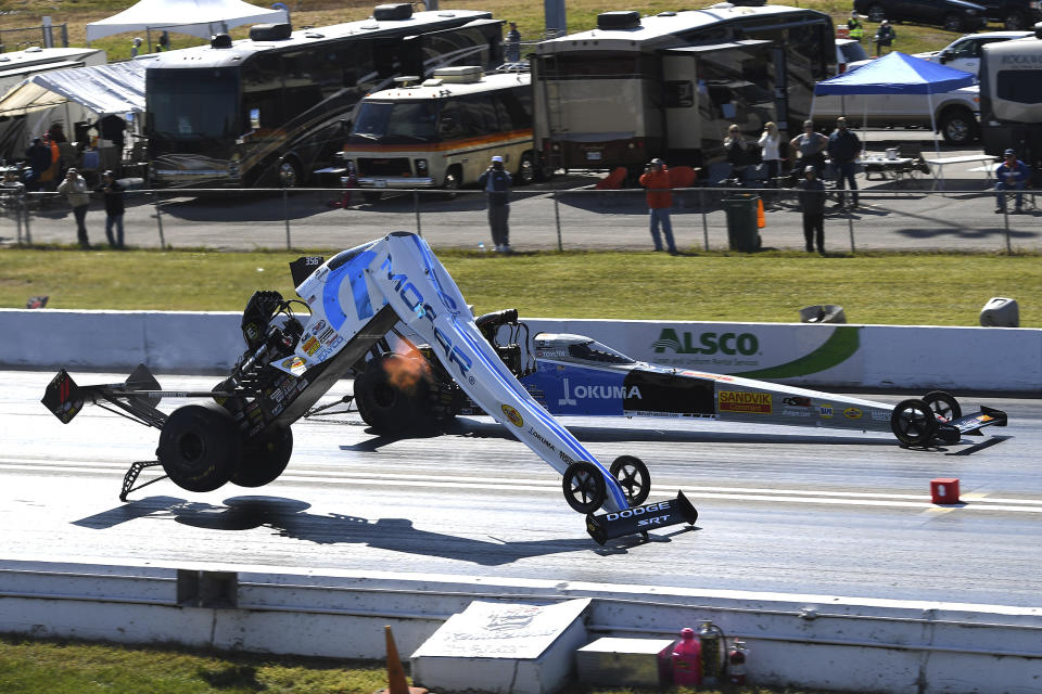 In this photo provided by the NHRA, Leah Pritchett's Top Fuel car breaks apart during the second round of eliminations at the Mopar Express Lane NHRA Midwest Nationals drag races Sunday, Oct. 4, 2020, at World Wide Technology Raceway in Madison, Ill. Pritchett walked away from the crash. (Gary Nastase/Auto Imagery via NHRA via AP)