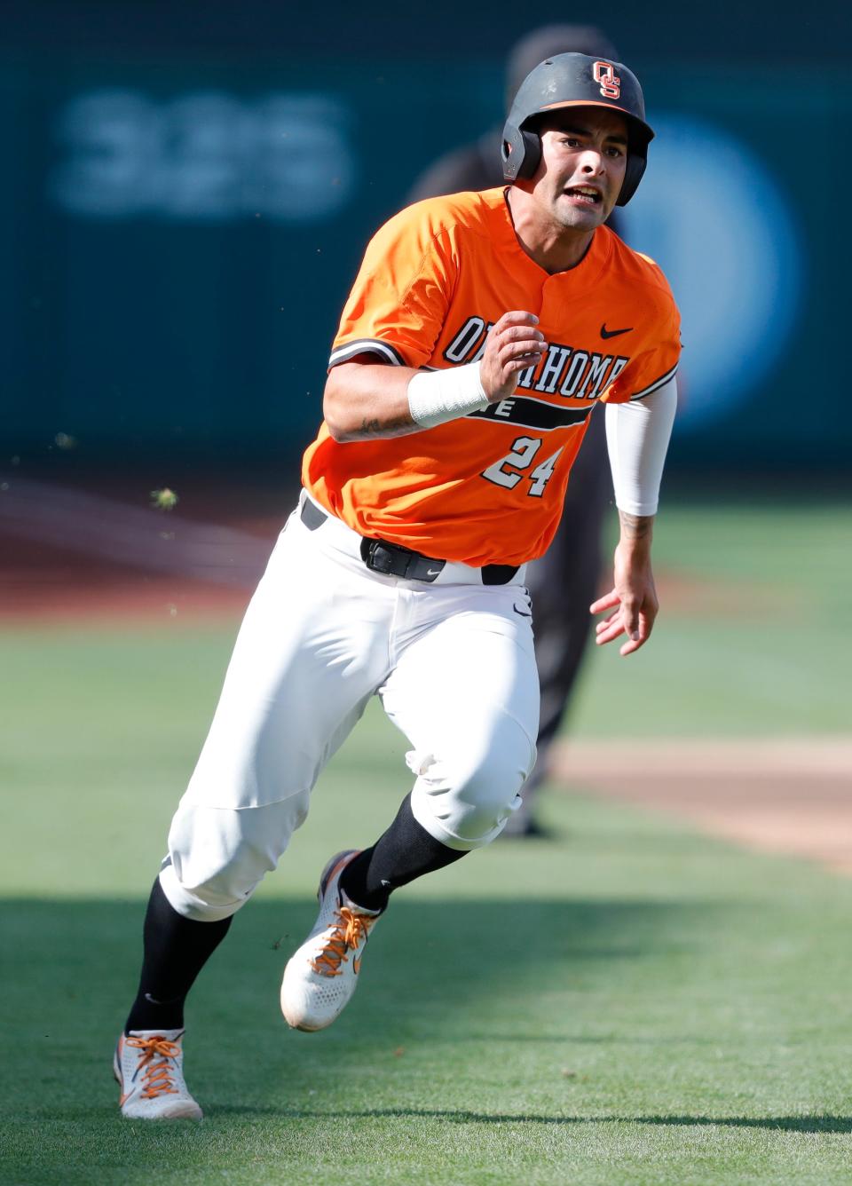 May 28, 2021; Oklahoma City, Oklahoma, USA; Oklahoma St. third baseman Christian Encarnacion-Strand (24) runs towards home plate against West Virginia during the Big 12 Conference Baseball Tournament at Chickasaw Bricktown Ballpark. Mandatory Credit: Alonzo Adams-USA TODAY Sports