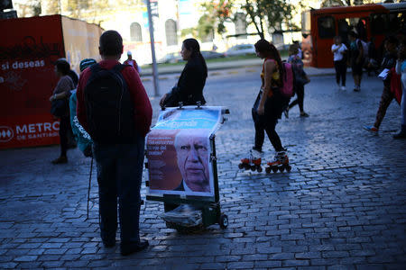An afternoon edition of a newspaper, with its frontpage with former Chile's president and center-left presidential candidate Ricardo Lagos, is seen after Lagos dropped out his presidential campaign, in Santiago, April 10, 2017. REUTERS/Ivan Alvarado