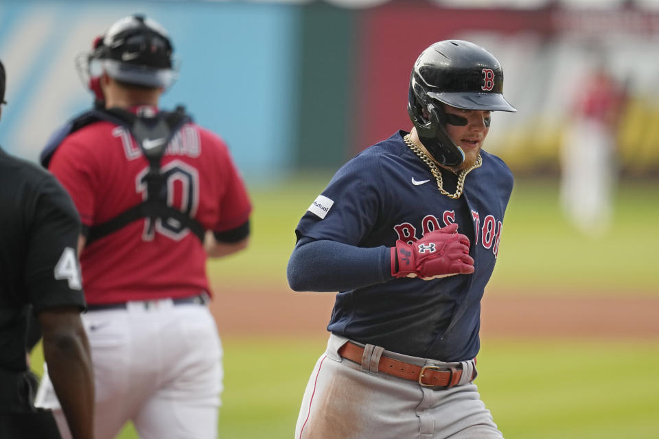 Boston Red Sox's Alex Verdugo, right, scores behind Cleveland Guardians catcher Mike Zunino, left, on a single by Rafael Devers during the first inning of a baseball game Wednesday, June 7, 2023, in Cleveland. (AP Photo/Sue Ogrocki)