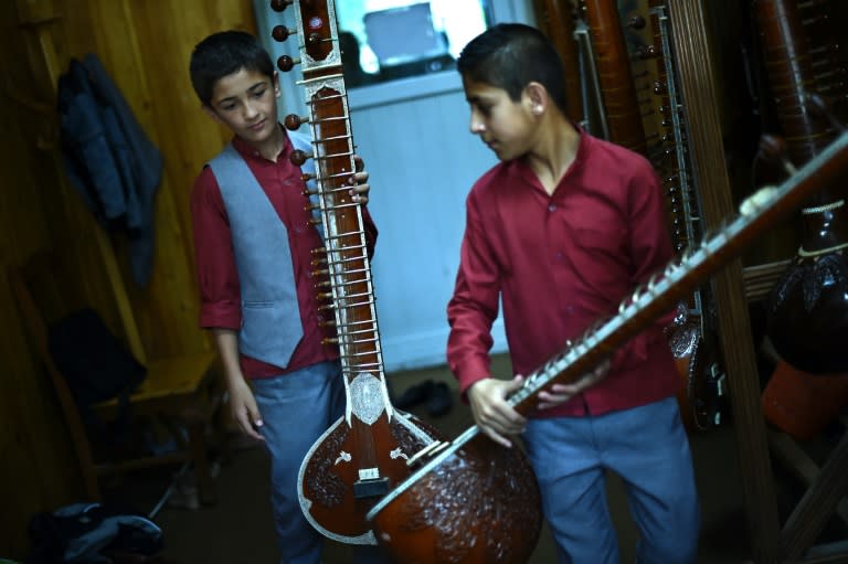 Afghan music students hold their sitars before practice at the Afghanistan National Institute of Music in Kabul Bolt upright in his gray suit, Wahidullah enchants his audience as his fingers play over the piano keys. It is a far cry from selling chewing gum on the streets of Kabul as he used to: now he studies Mozart and Schubert at Afghanistan's National Institute of Music, which overcomes conservative reluctance to provide an education for the capital's street children