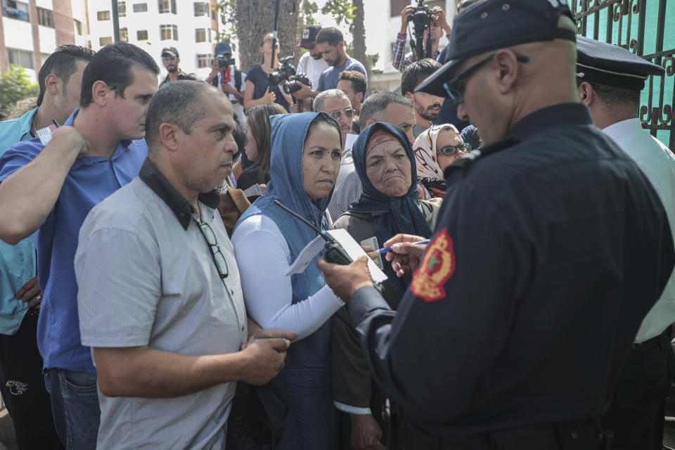 Observers and relatives prepare to enter a court where journalist Hajar Rissouni is being tried on accusations of undergoing an illegal abortion, in Rabat, Morocco, Monday, Sept. 30, 2019. The 28-year old Moroccan journalist Hajar Raissouni was sentenced to one year in prison, while her fiancé also received a one-year sentence and the doctor accused of terminating the pregnancy was sentenced to two years in jail and suspended from practicing. (AP Photo/Mosa'ab Elshamy)