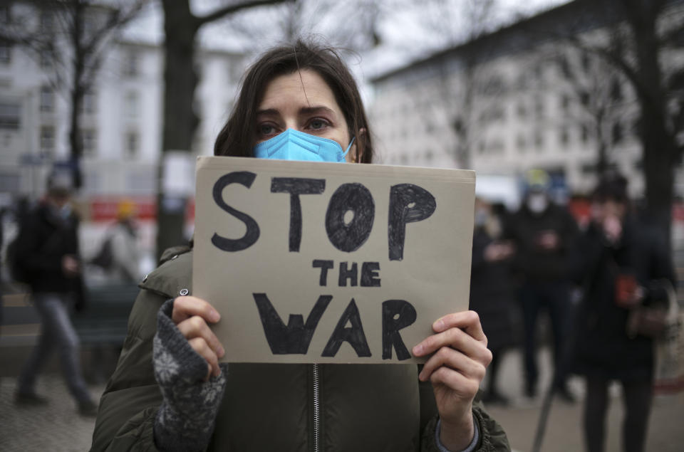 A woman attends a protest against the Russian invasion in the Ukraine in front of the Russian embassy in Berlin, Germany, Friday, Feb. 25, 2022. (AP Photo/Markus Schreiber)