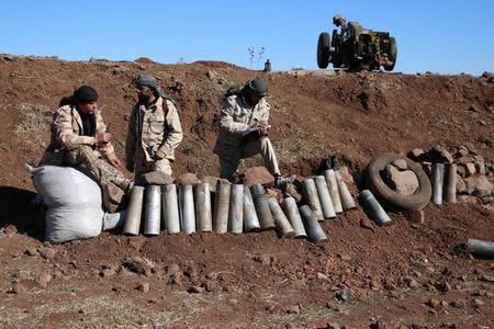 Rebel fighters stand near empty rockets in Jubata al-Khashab, Quneitra province, Syria November 26, 2016. REUTERS/Alaa Al-Faqir