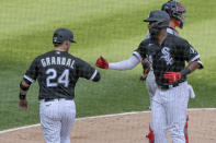 Chicago White Sox Yasmani Grandal (24) congratulates Eloy Jimenez (74) on his two run homer against the St. Louis Cardinals during the fourth inning in game two of a double-header baseball game Saturday, Aug. 15, 2020, in Chicago. (AP Photo/Mark Black)