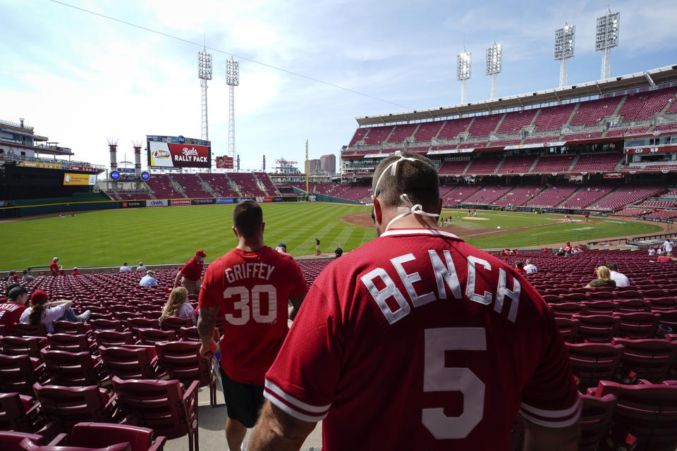 Cincinnati fans find their seats at Great American Ball Park before a baseball game between the Cincinnati Reds and the Pittsburgh Pirates in Cincinnati, Tuesday, April 7, 2021. (AP Photo/Bryan Woolston)