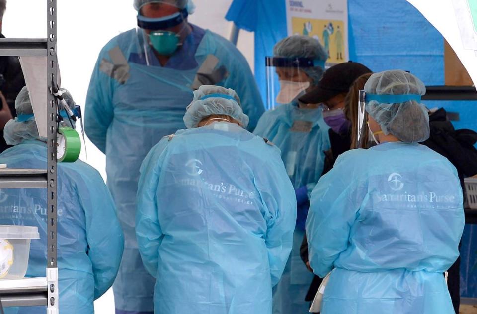 Samaritan’s Purse nurses pray prior to the arrival of COVID-19 patients at the emergency field hospital at Caldwell Memorial Hospital on Thursday, January 7, 2020 in Lenoir, NC.