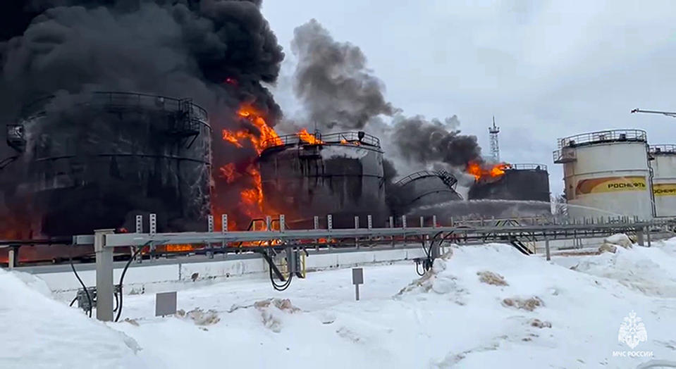 In this photo taken from video released by Governor of Bryansk Region Alexander Bogomaz telegram channel AV BogomaZ on Friday, Jan. 19, 2024, Russian Emergency Ministry employees work at the side of fire of oil reservoirs after the drone reached Klintsy, a city in Bryansk Region of Russia, about 60 kilometers (40 miles) from the Russia-Ukrainian border. A Russian official says a Ukrainian drone has struck an oil storage depot in western Russia, causing a massive blaze. (Governor of Bryansk Region Alexander Bogomaz telegram channel AV BogomaZ via AP)