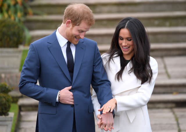 <p>Karwai Tang/WireImage</p> Prince Harry and Meghan Markle in the Sunken Garden at Kensington Palace after announcing their engagement on Nov. 27, 2017.