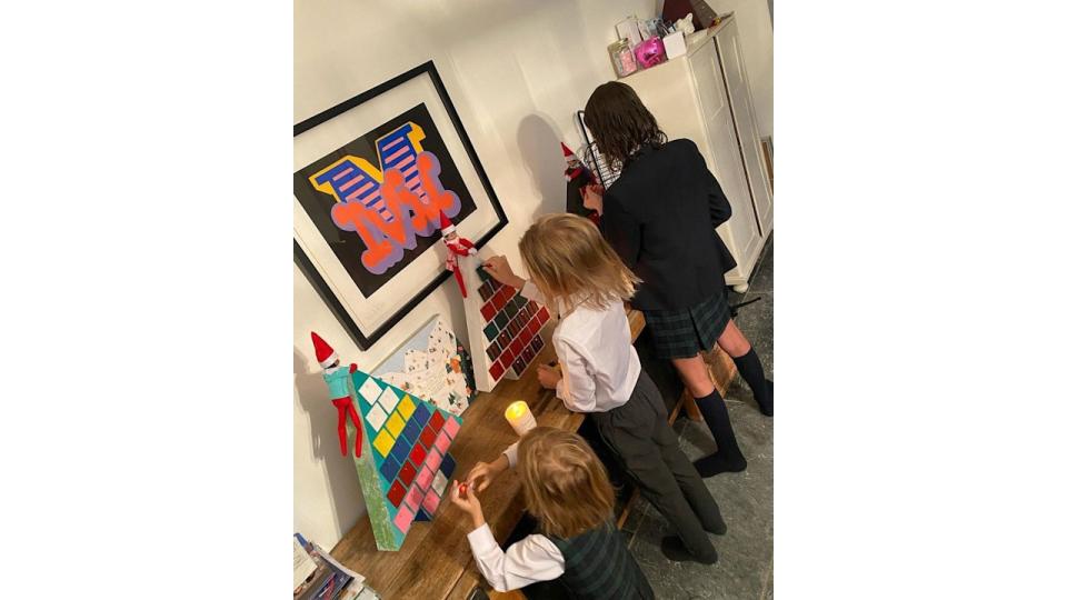 Emma and Matt Willis three children open their advent calendar in their dining room