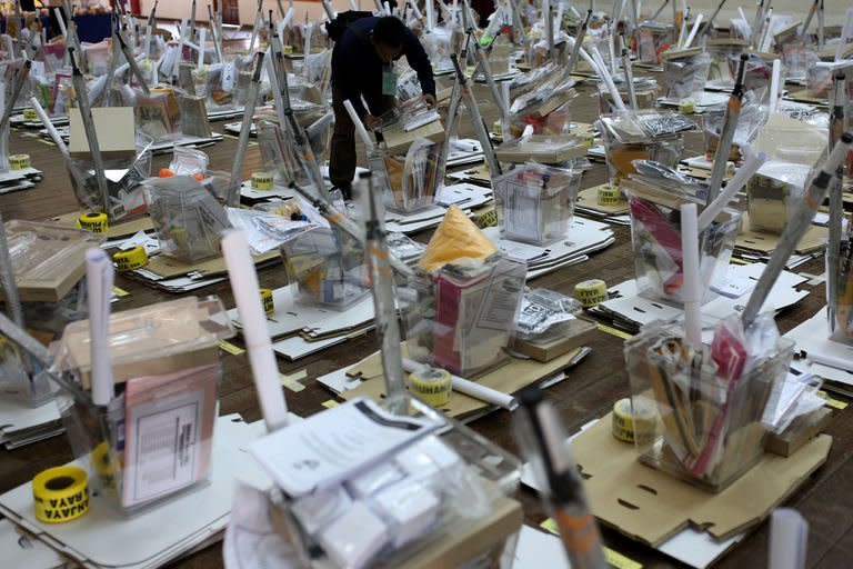 A polling agent checks materials a day before the 13th general elections in Ampang, the suburbs of Kuala Lumpur on May 4, 2013