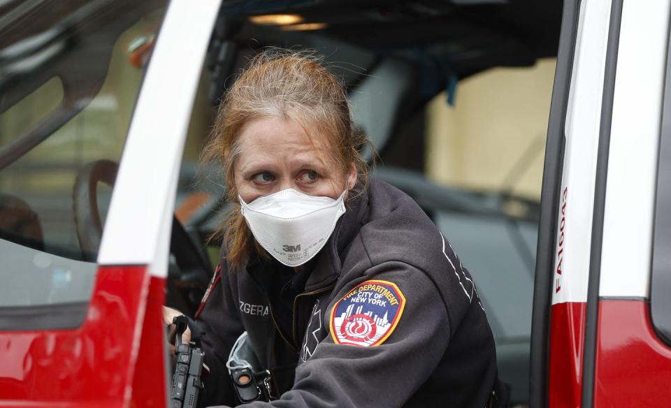 <span class="caption">Health care workers, first responders and others on the front lines are at risk for depression from COVID-19. Here, a first responder in New York City is pictured March 25, 2020, outside a testing site at Elmhurst Hospital Center.</span> <span class="attribution"><a class="link " href="http://www.apimages.com/metadata/Index/Virus-Outbreak-New-York/f58e27a76d08423a85a2d5fc180b5833/31/0" rel="nofollow noopener" target="_blank" data-ylk="slk:AP Photo/John Minchillo;elm:context_link;itc:0;sec:content-canvas">AP Photo/John Minchillo</a></span>