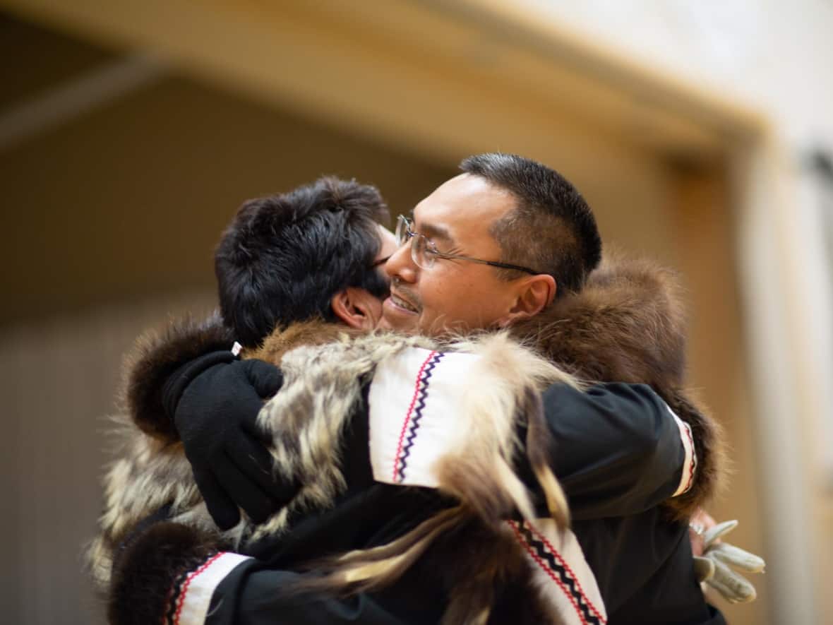 Herman Oyagak, right, embraces his wife, Carol Oyagak. Herman, an Inupiaq man living in the N.W.T., has had his deportation to Alaska deferred. (Submitted by Nick Sowsun - image credit)