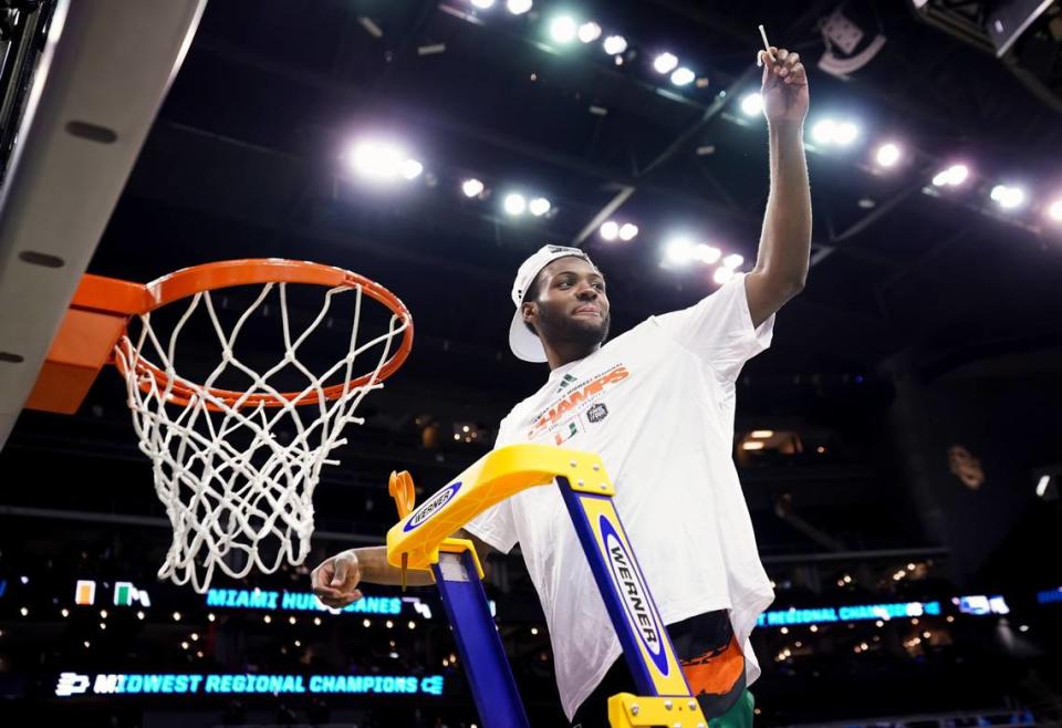 Miami’s Wooga Poplar (55) cut down the nets after hitting 6 of 7 shots to help the Hurricanes earn a berth in the 2023 NCAA Tournament Final Four with an 88-81 win over Texas in the round of eight.