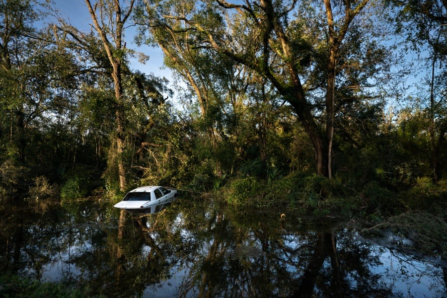 A vehicle that crashed after hitting a fallen tree sits in a gully after Hurricane Idalia crossed the state on August 30, 2023 in Perry, Florida. The storm made landfall at Keaton Beach, Florida as a category 3 hurricane. (Photo by Sean Rayford/Getty Images)