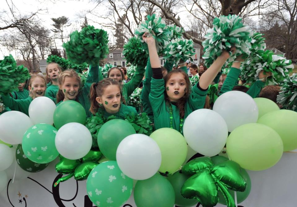 Dancers from the Etoile Yoga and Dance studio of Pembroke send out a cheer as they make their way along the Scituate St. Patrick's Parade route, Sunday, March 20, 2022.